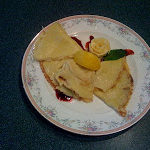 White plate trimmed in flowers topped with English pancakes