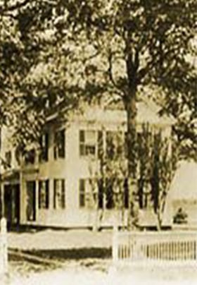 Black and white vintage historic exterior back view of Captains House Inn