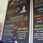 Chalkboard sign with colorful menu items at Arnold's Lobster & Clam bar in Eastham in Cape Cod