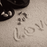 The word, Love, drawn in the sand