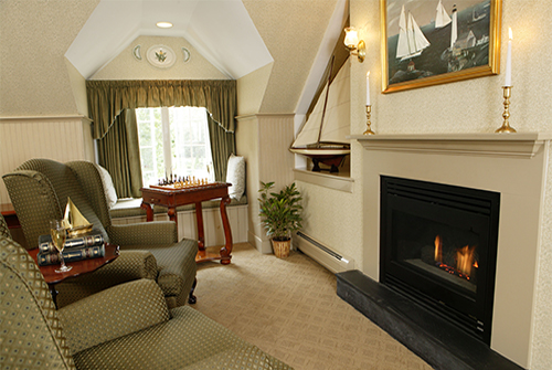 Lydia Harding suite with window, upholstered wing chairs and fireplace