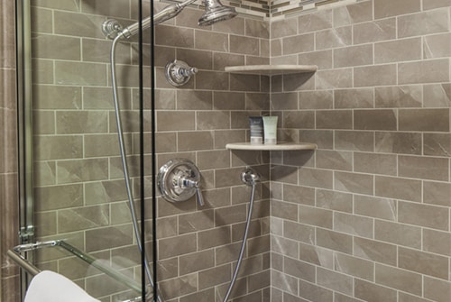 Northern Light double shower with grey and brown tiles and multiple shower heads