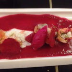 White rectangular plate topped with beet gazpacho