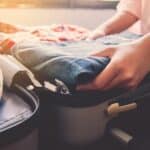 A person packing their luggage for a getaway